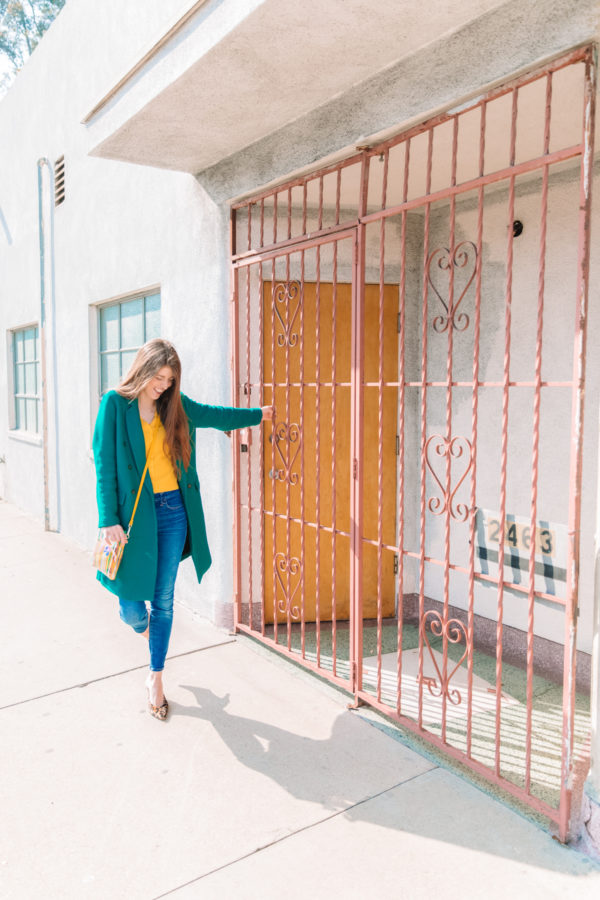 A person standing next to a fence