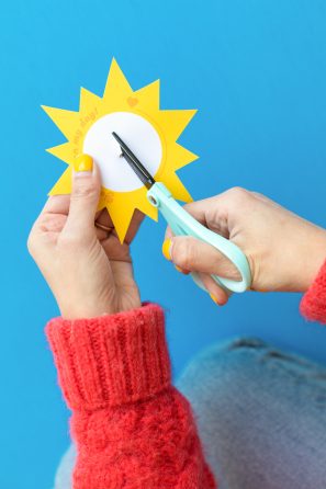 Someone cutting a sun