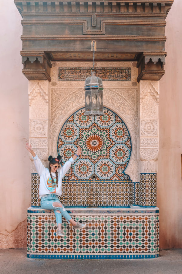 A woman sitting on a fountain