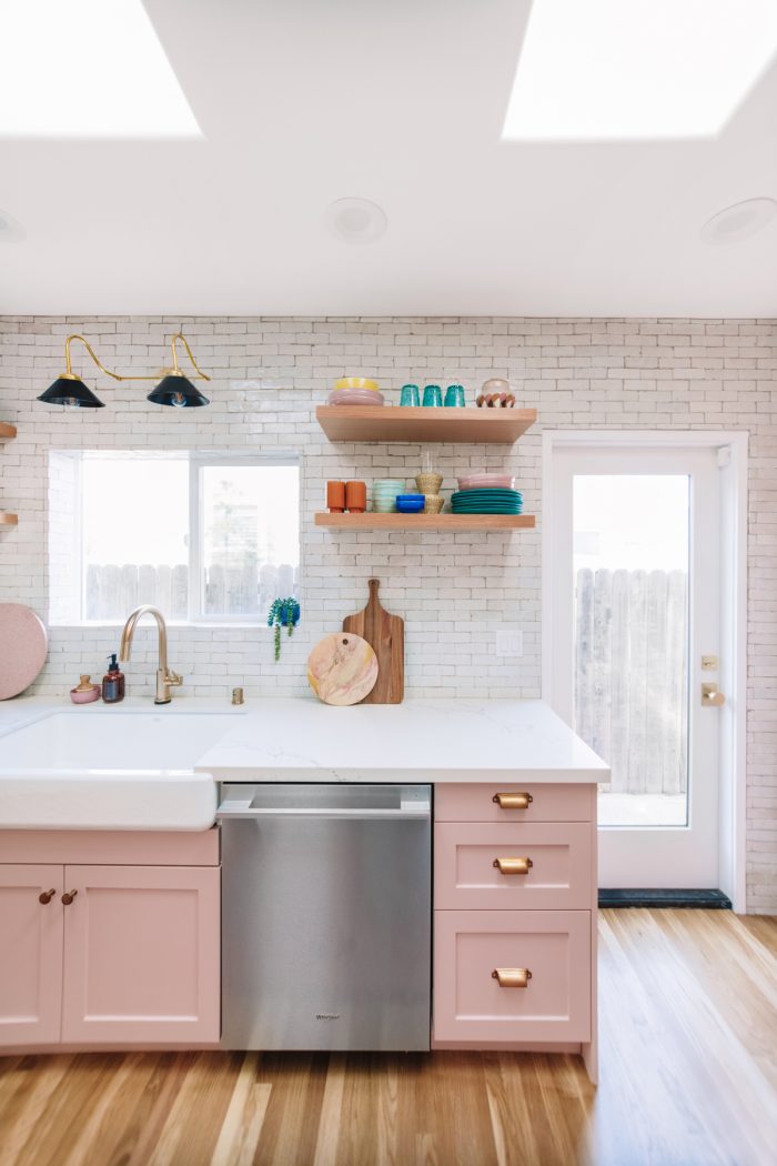 A kitchen with a door and window