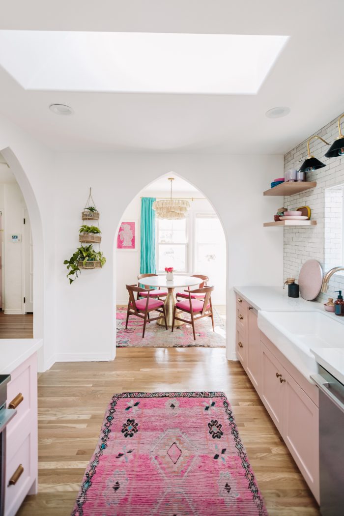 A kitchen with a table in a room