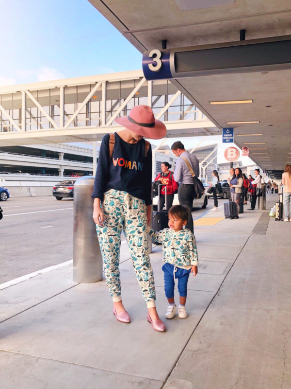 Two people standing at an airport