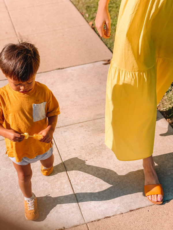 A little boy wearing orange