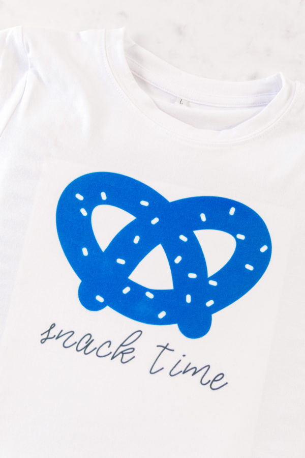 A close up of a blue pretzel on a shirt