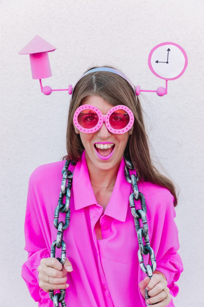 A woman wearing pink sunglasses and a pink shirt