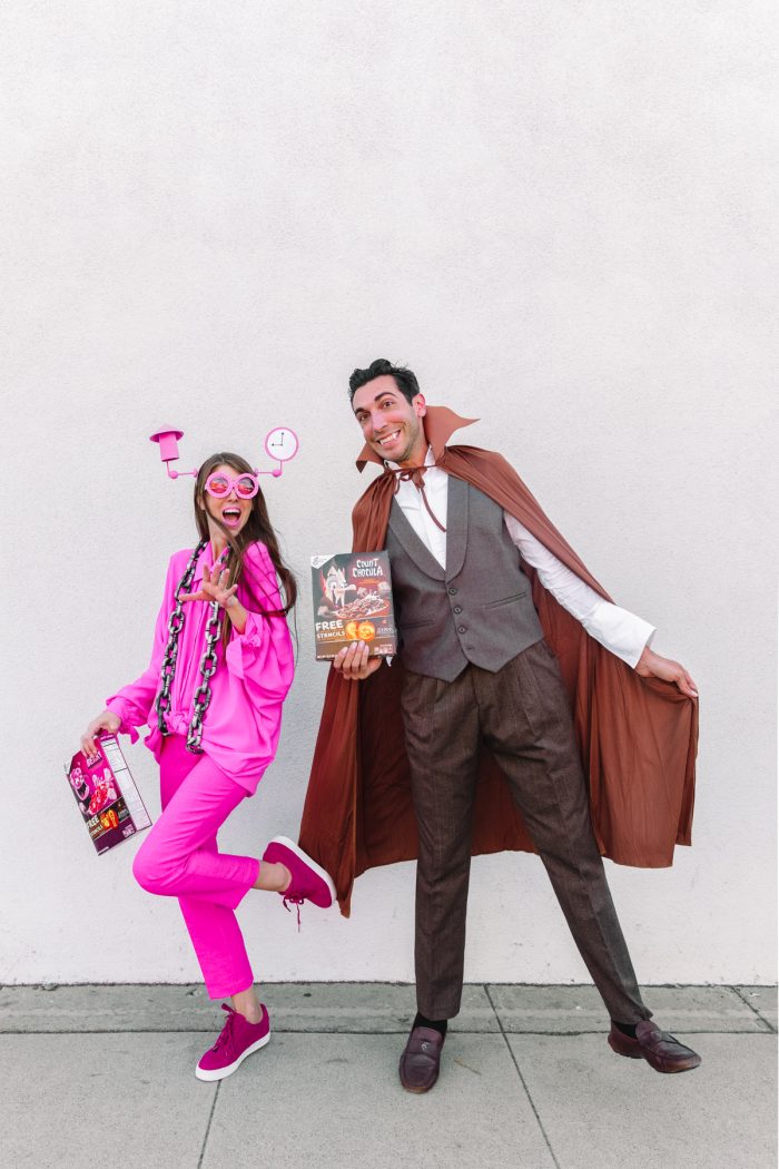 A man and a woman posing and wearing a costume