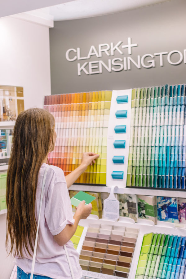 A person looking at paint samples