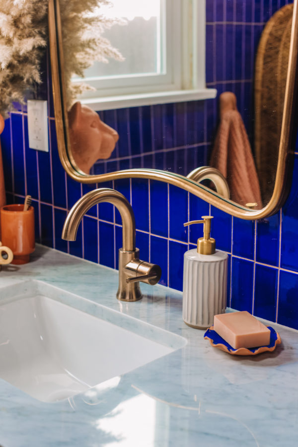 A close up of a sink and a mirror