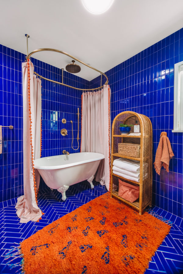 A room with a blue tiled wall