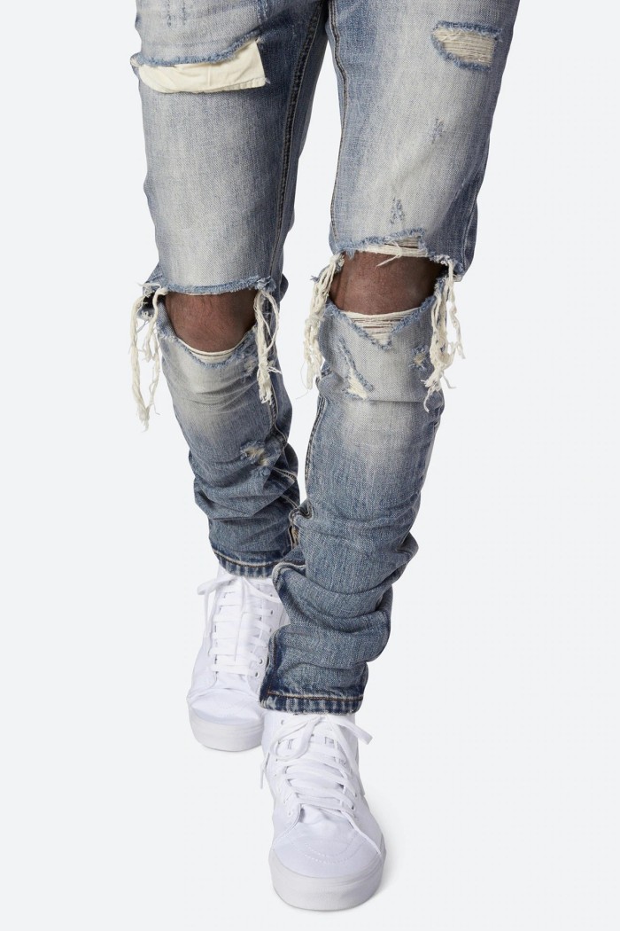Ripped jeans on man with white sneakers