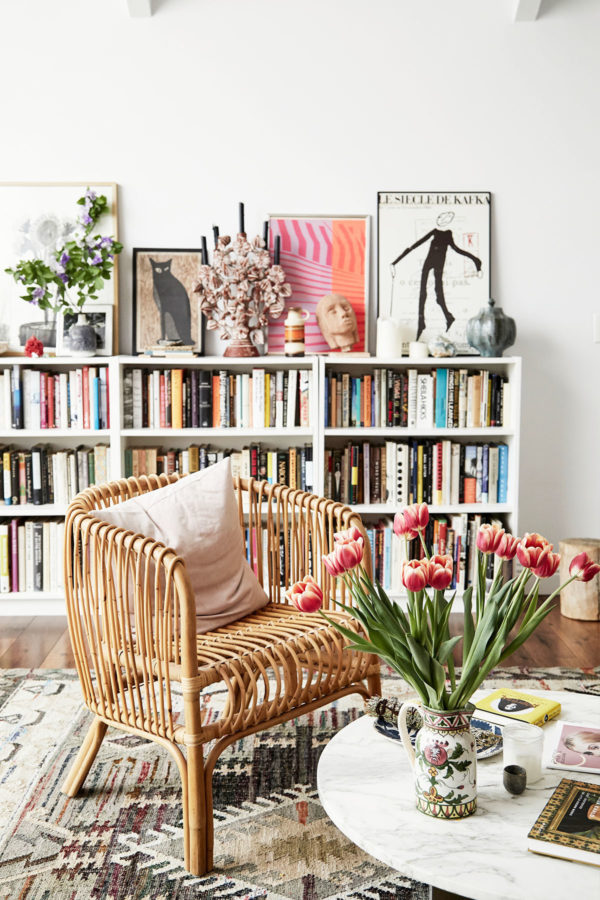 bookshelf and rattan chair