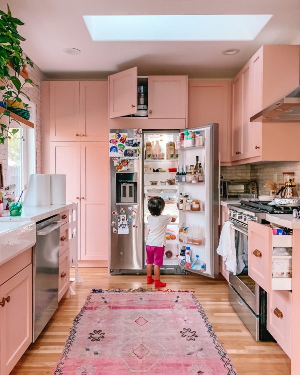 A kitchen with pink cabinets