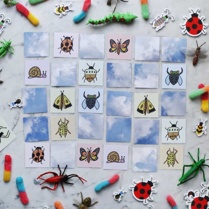 Insect memory game on a floor with toys.