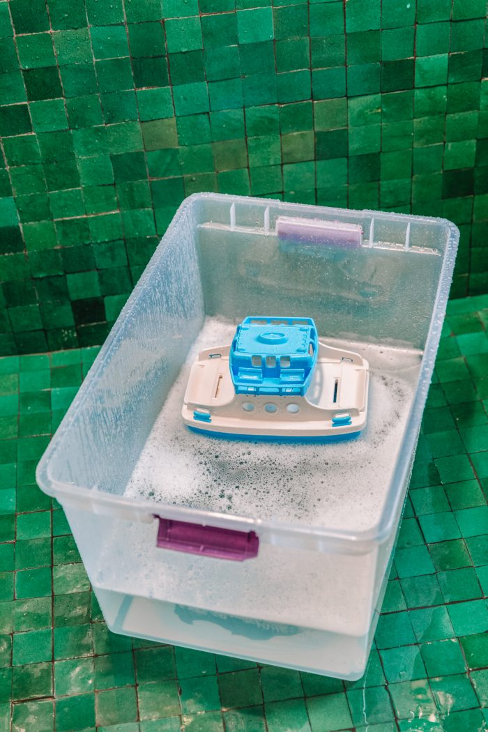 A bucket of soap in a bathroom