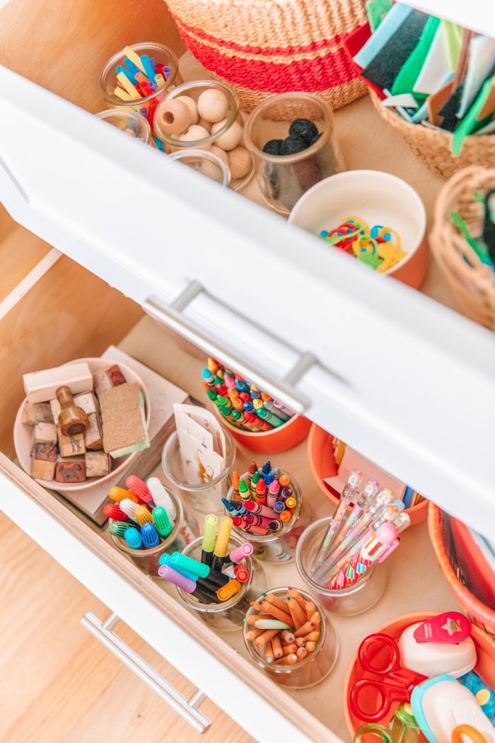 A drawer with pens and pencils