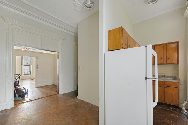 The corner of a kitchen and a wooden floor