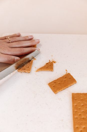 Someone cutting a graham cracker