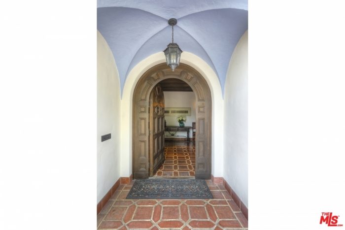 The entrance to a spanish style house with tile