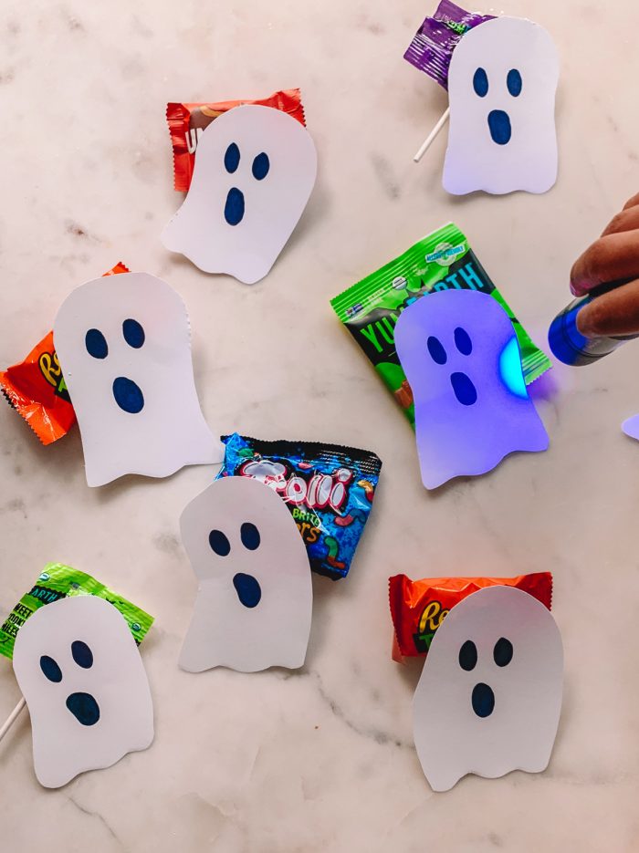Black Light Halloween Candy Hunt with Paper Ghosts