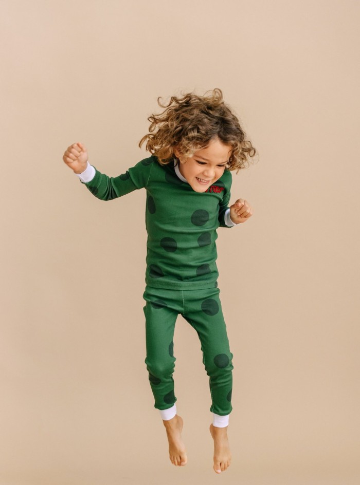 child in green polka dot pajamas