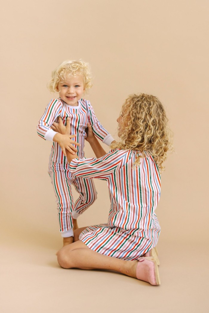 Two kids in striped holiday pajamas