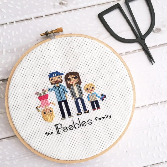 family cross stitch portrait on table with scissors
