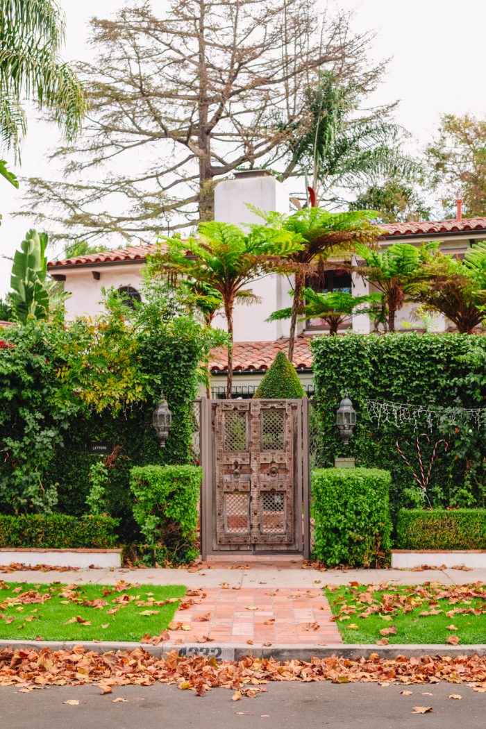 The front of a Spanish house with lots of plants