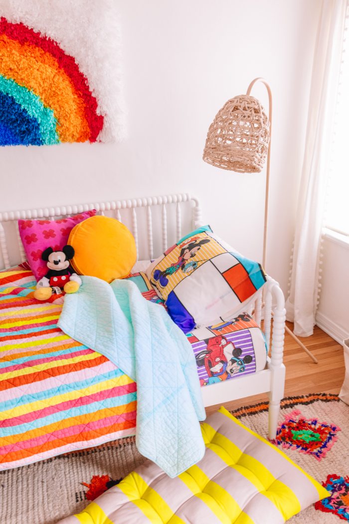 A room with a colorful bed