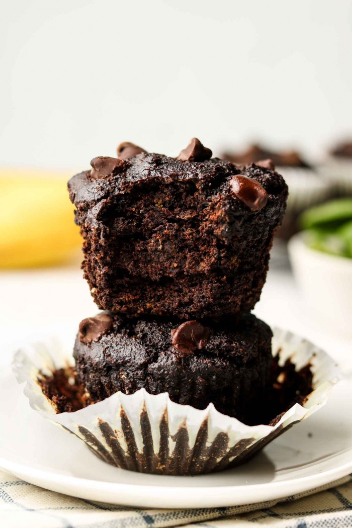 chocolate green smoothie muffins stacked on top of each other on a plate