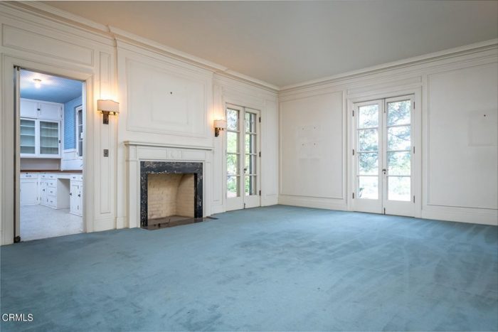 A large room with blue rug