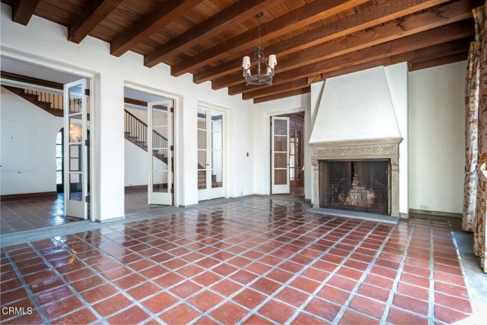 An empty room with a fireplace and tiles