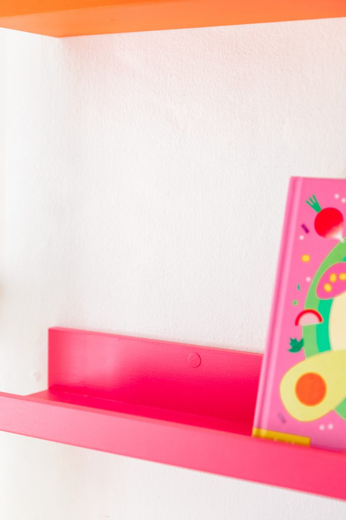 A close up of a pink shelf