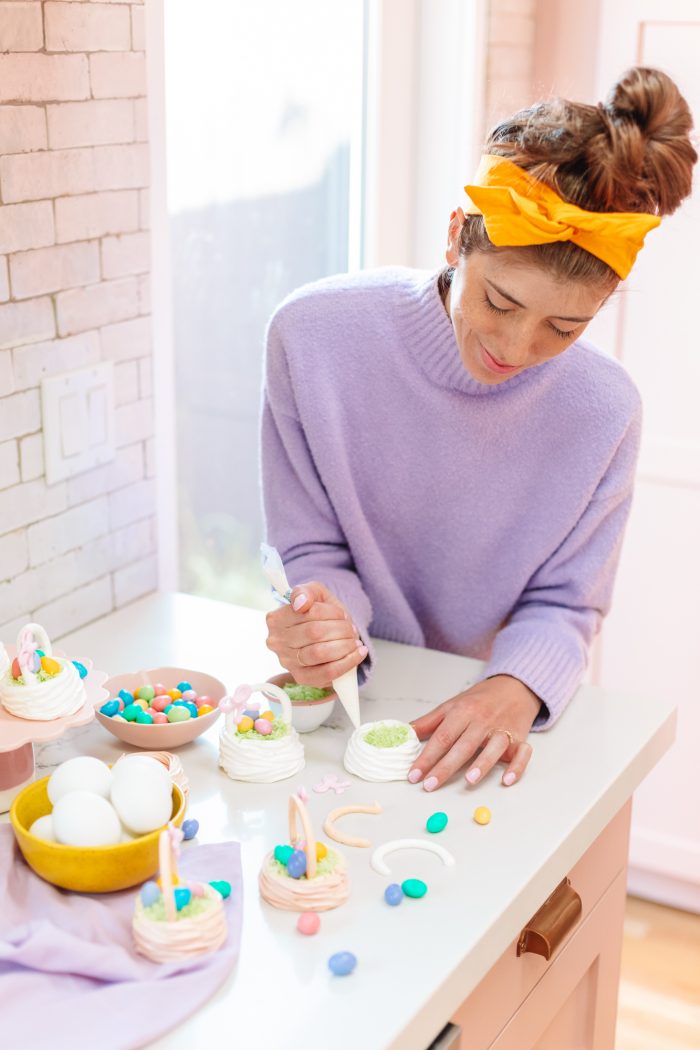 A woman making small easter baskets