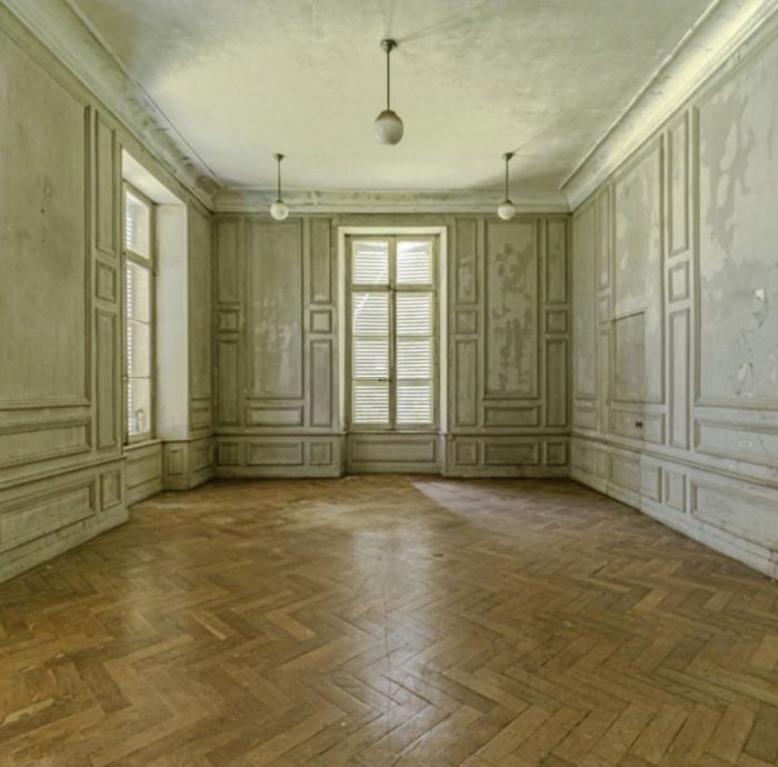 A large empty room with a wood floor