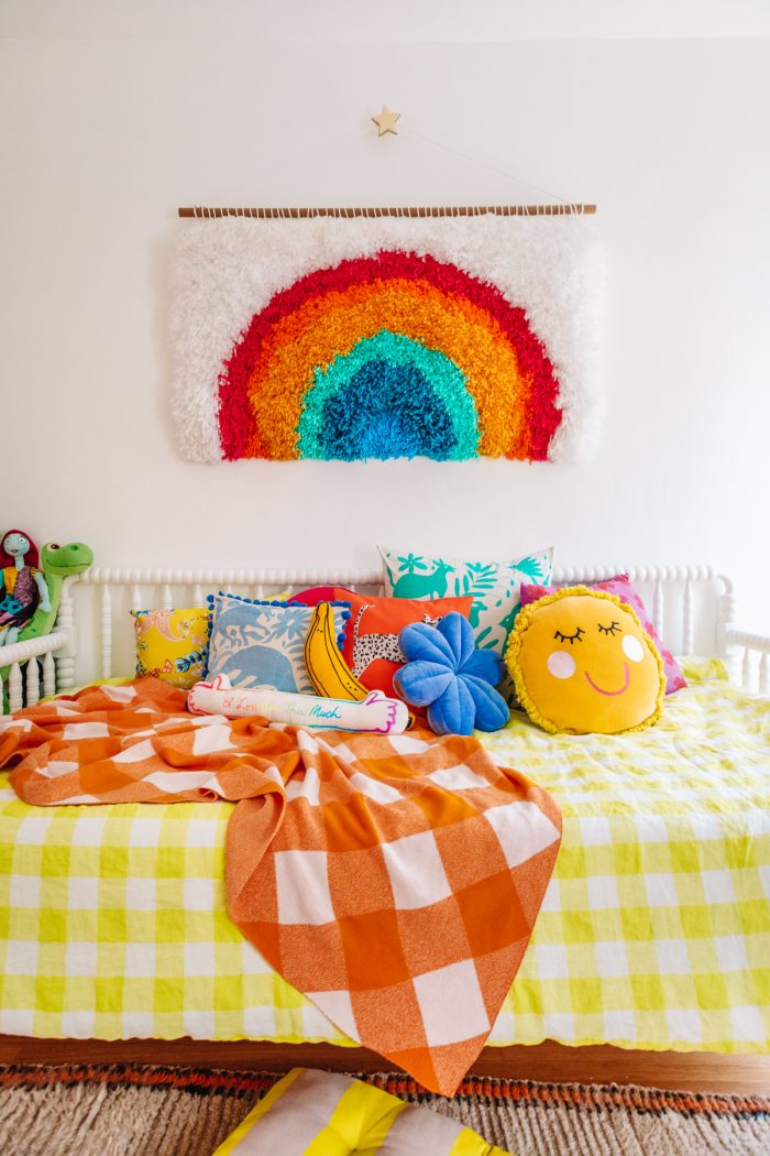 A bed with a colorful blanket