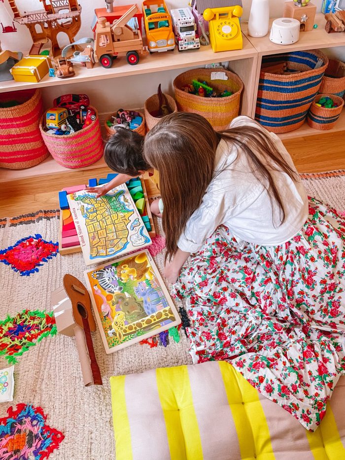 woman and child looking at puzzles