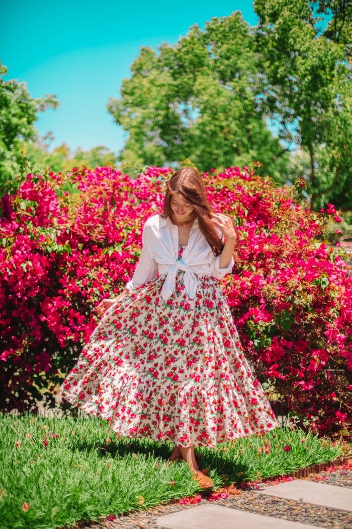 A woman standing in front of flowers