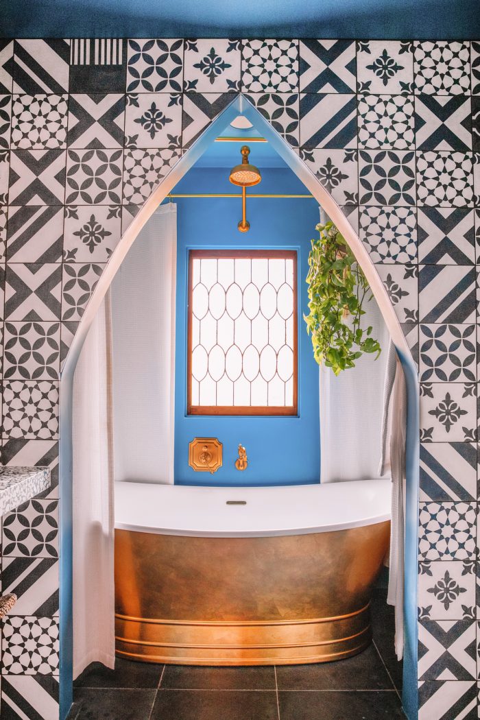 Blue Bathroom with Tiled Arch and Copper Tub in Yucca Valley
