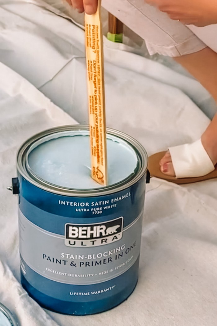 Can of blue BEHR Paint being stirred