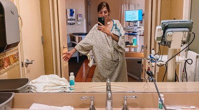 Woman in hospital gown in hospital bathroom