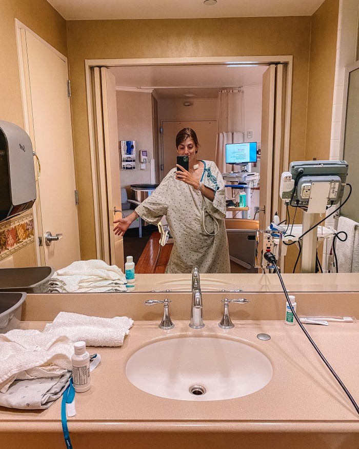 Woman in hospital gown in hospital bathroom