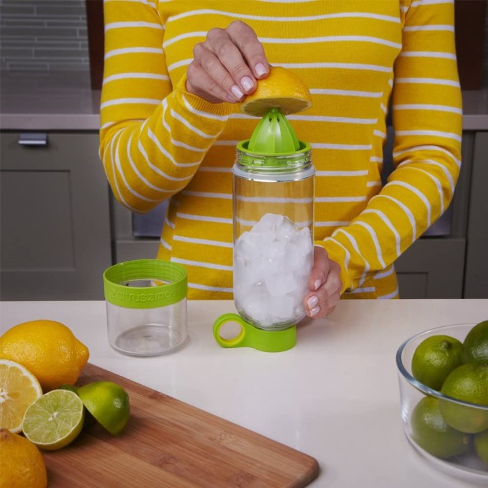 Green water bottle with lemon sitting on top