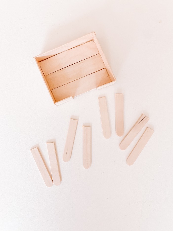 Popsicle sticks laid on a white table