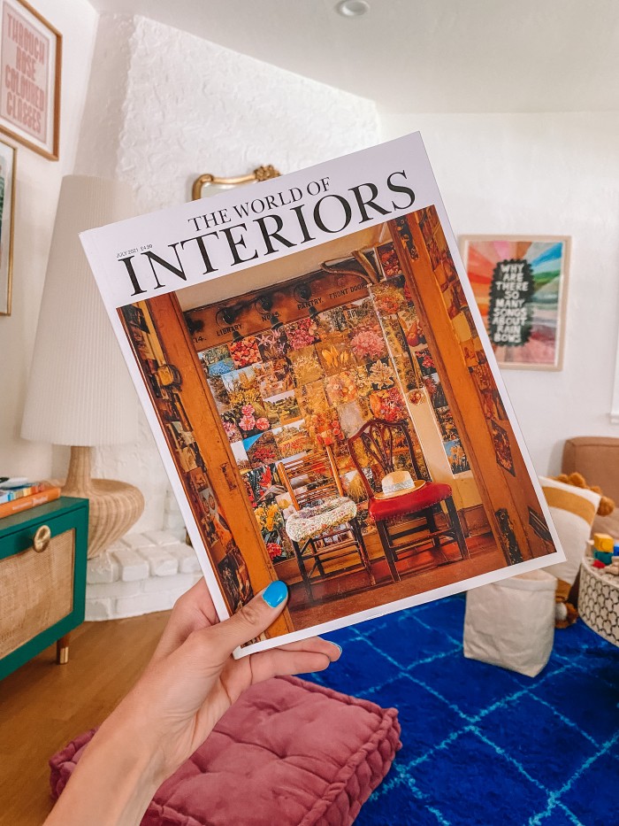 World of Interiors magazine held in front of a blue living room rug