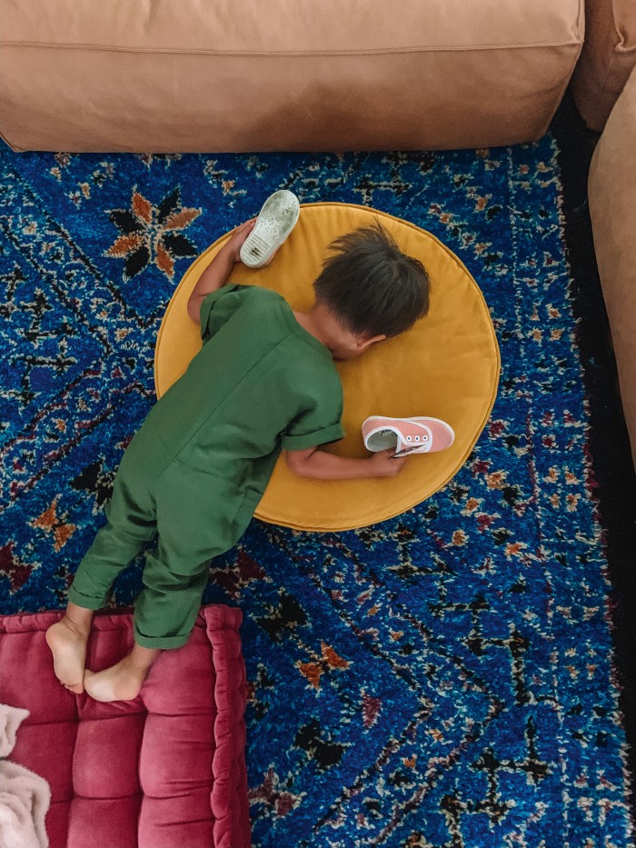 Blue living room rug with child laying on top