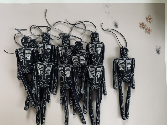 Black Skeleton Dolls in a pile on a table