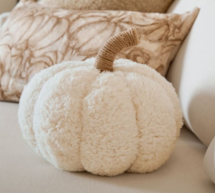 plush white pumpkin pillow on white couch