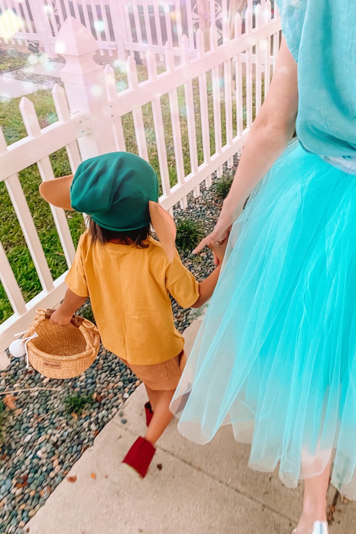 Child in Gus Gus Halloween costume and mom in cinderella costume walking