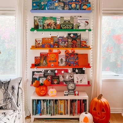 Rainbow bookshelves with Halloween kids books on them