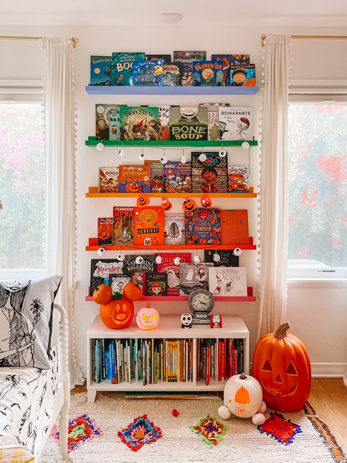 Rainbow bookshelves with Halloween kids books on them